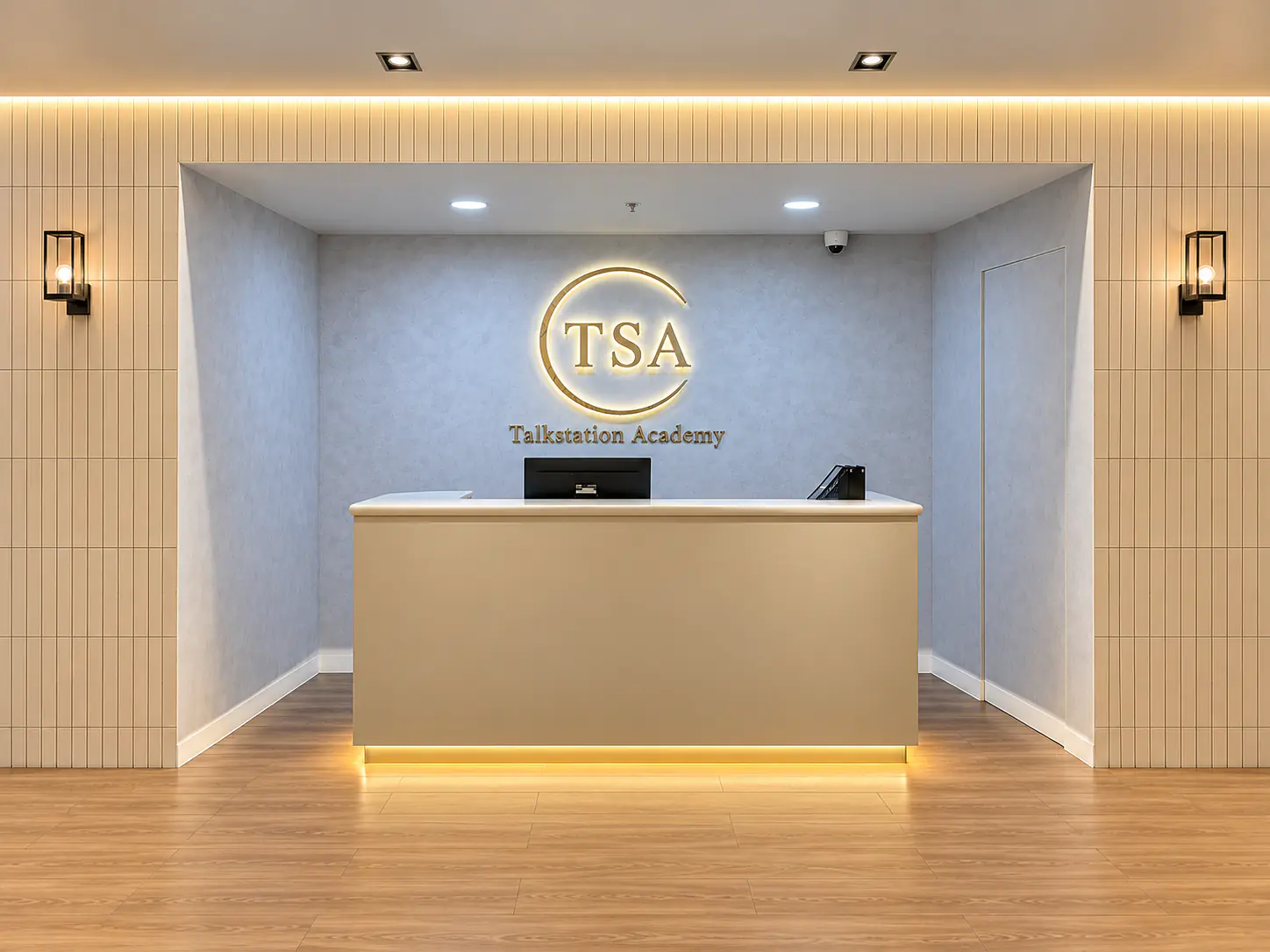 TSA reception desk beneath the Talkstation Academy sign